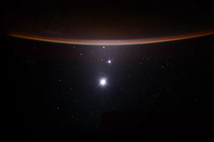 From bottom to top, Earth's Moon, Venus, Jupiter and a sliver of the crescent of Earth at the top. The image was taken from aboard the International Space Station in 2015. Credit: NASA/Scott Kelly