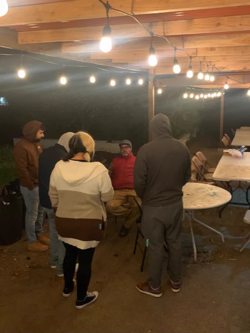 Cal Poly Pomona marketing students talk with Farmer Stephen Yorba at Lopez Urban Farm. 