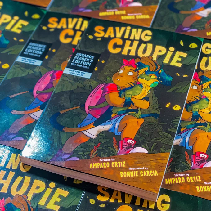 Image features paperback copies of middle grade graphic novel SAVING CHUPIE, all in advanced reader copy format