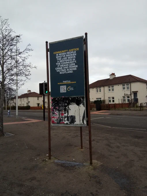 One poster displayed at a road junction