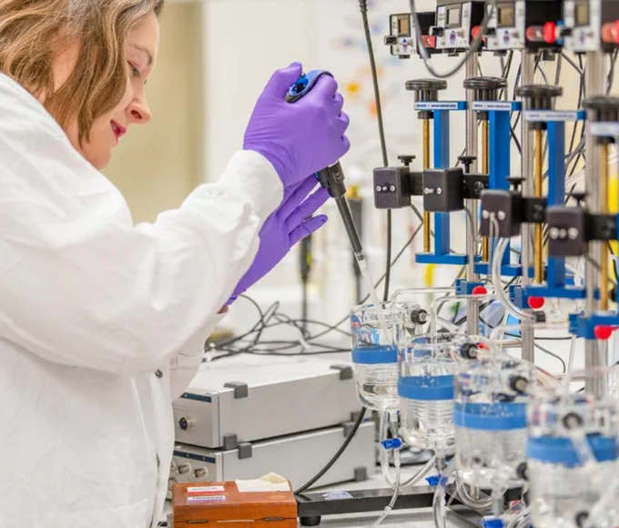 Female scientist working in lab from the report cover