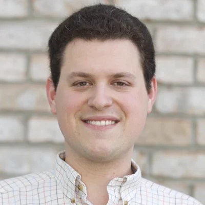 headshot of Dr Sean Kross standing in front of brick wall