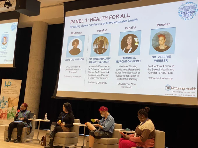 A picture of the panelists & moderator on stage during the “Health for All” panel.