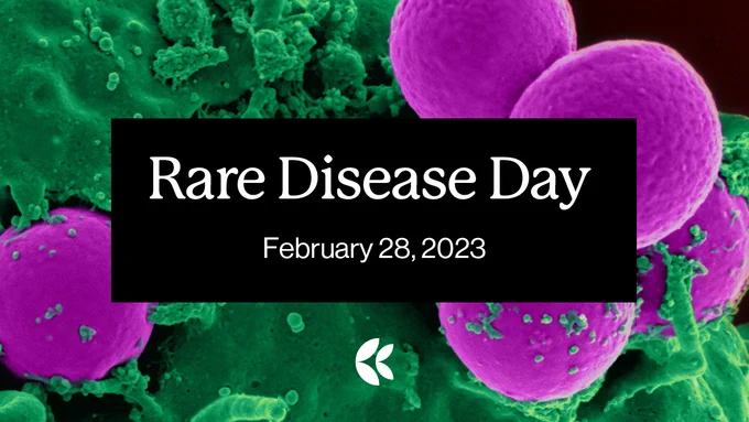 Green and pink microscopic image of cellular material. Text: Rare Disease Day, February 28, 2023. 