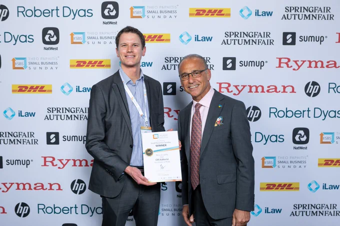 Photo of Craig Smith of CRS Editorial collecting his Small Business Sunday winner's certificate from Theo Paphitis.