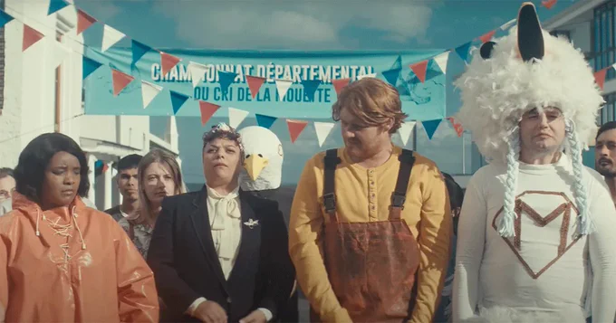 four people in costumes stand in a crowd in a street fair 