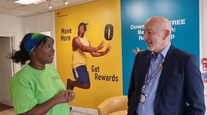 Image shows council chief executive Tim Johnson speaking to Better Health: Rewards Champion Martha Cummings