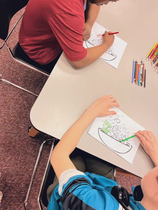 Students coloring salad images with colored pencils
