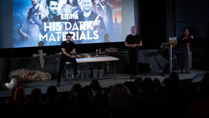 Brian Fisher and Eliot Gibbin showing His Dark Materials puppets on stage in Chapter at Cardiff Animation Festival 2022. 