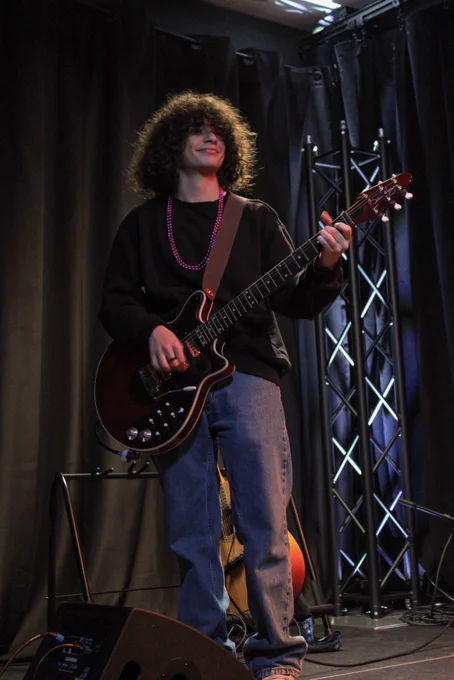 Student performing with a guitar
