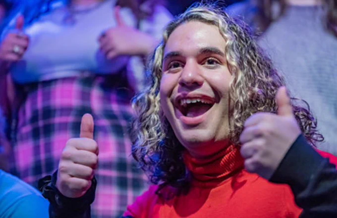 Student smiling with two thumbs up