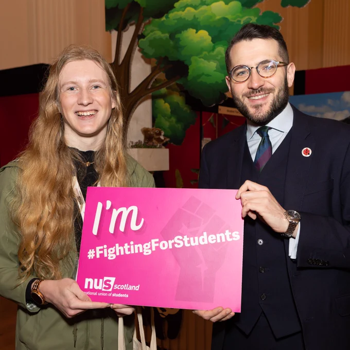 Picture of Paul Sweeney MSP holding up a NUS Scotland sign that says " I'm Fighting For Students".
