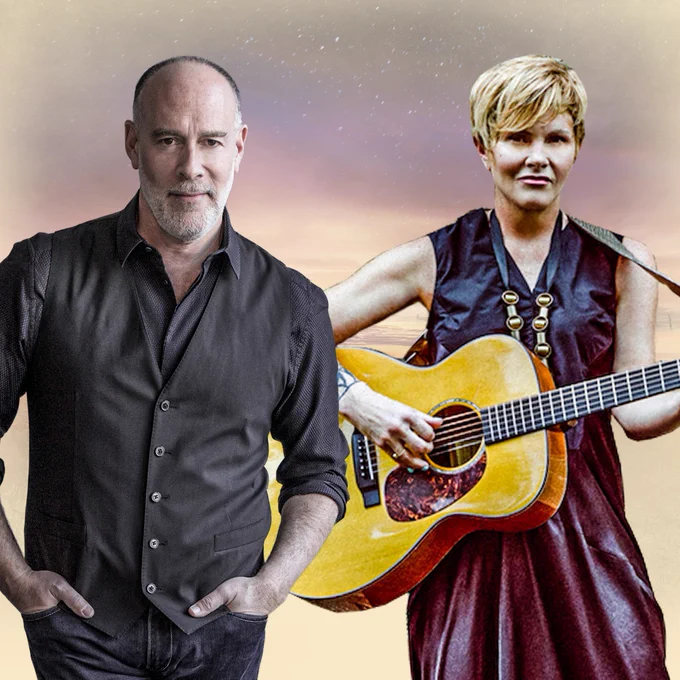 3Marc Cohn stands with hands in pockets and Shawn Colvin plays a guitar.
