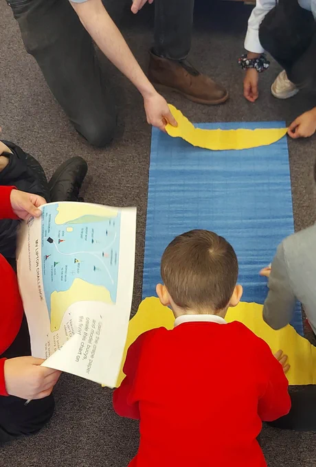 School children taking part in an activity using maps.