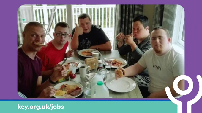 Five men on holiday, sitting at a dining table eating their friend breakfasts.