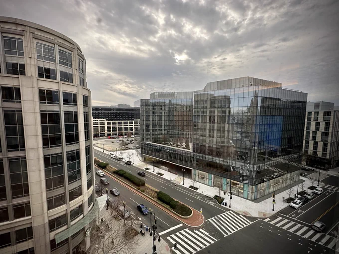 View of a city intersection in Washington DC with an open view of the cloudy morning sky.