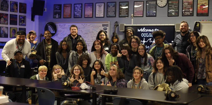 Student and adult musicians posing for a group photo.