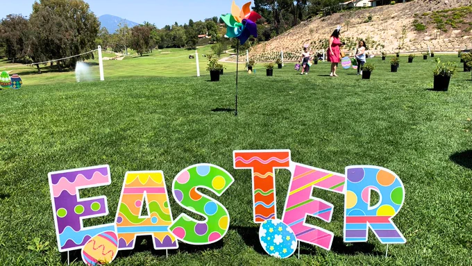 easter sign on golf course grass and kids in background