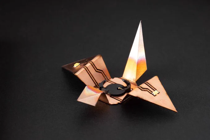 A kirigami circuit crane with 2 leds on its wing.