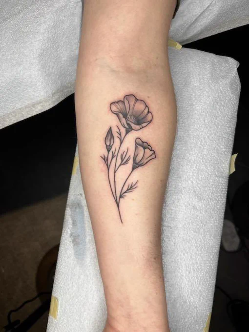 Close up of the finished poppy tattoo on my forearm. Lots of dope shading, very cute.