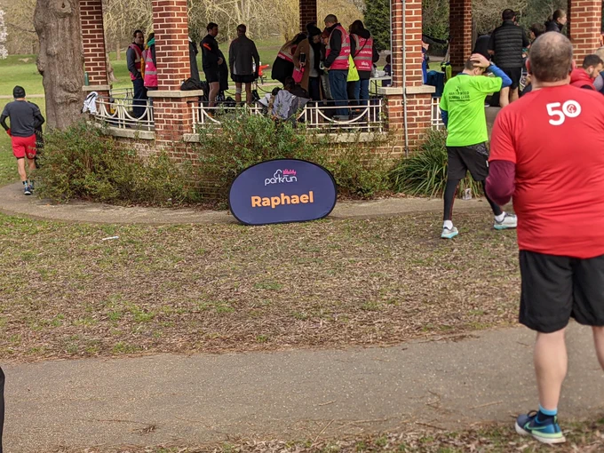 Raphael parkrun sign in front of the band stand in Raphael's park