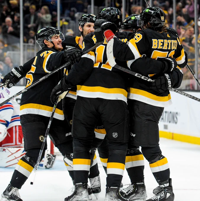The Boston Bruins celebrate a goal in alternate Bruins uniforms. 
