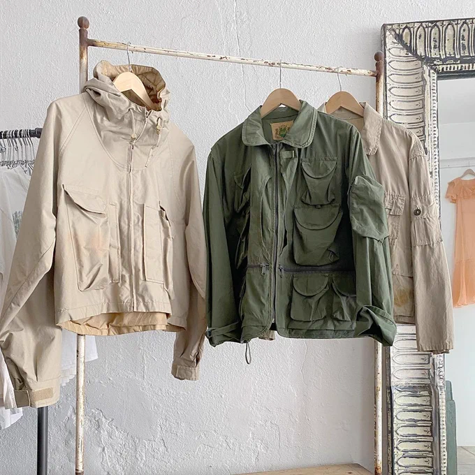Vintage fishing jackets from an American company called Ideal. They are colored beige and green; they have tons of pockets. 