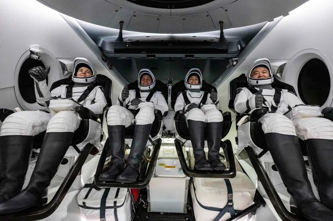 The four crew members of Crew-5—Anna Kikina, Josh Cassada, Nicole Mann and Koichi Wakata—are seen in their Dragon Endurance spacecraft shortly after splashing down off the coast of Tampa, Florida. The four are strapped into their chairs and wearing full flight suits. NASA/Keegan Barber