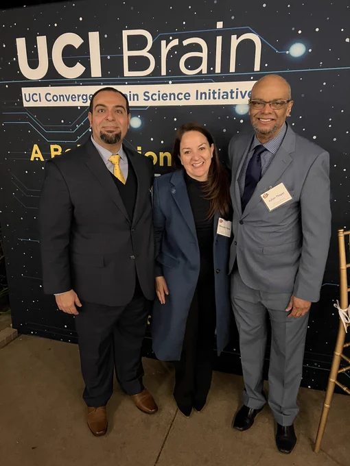 Photo of Mike Yassa, Manuella Yassa and Julian Thayer standing in front of a UCI Brain background.