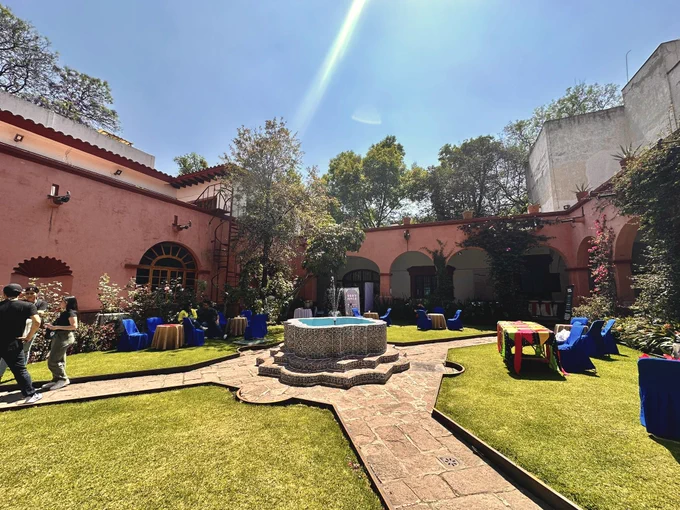 The garden in the conference venue, with fountain in the middle and sun shining on the grass.