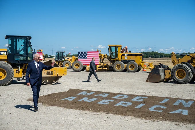 President Biden walks across side that reads "Made in America."