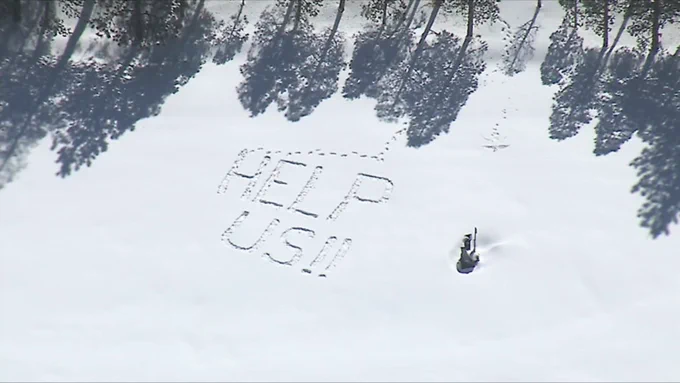 Aerial photo of a message tramped in the snow in Crestline, CAL "HELP US!!"