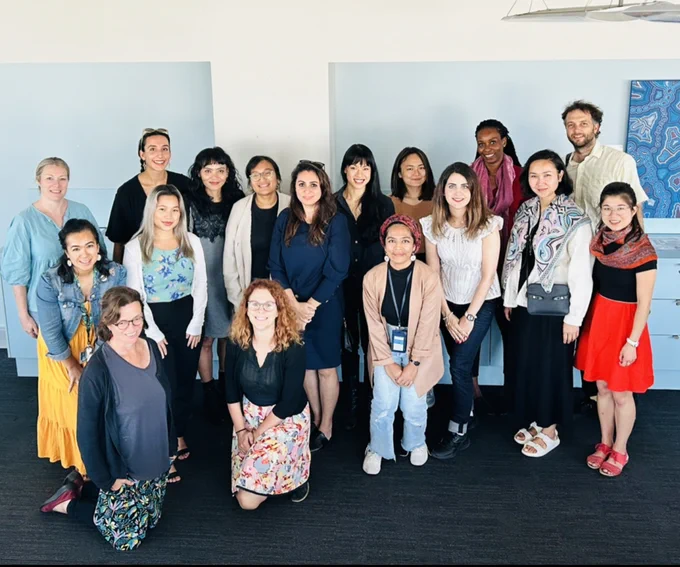 Group photo of 17 people smiling at the camera.