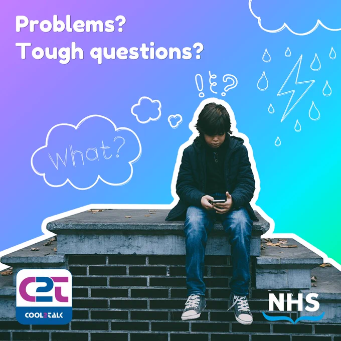 A boy is sitting on a wall looking worried