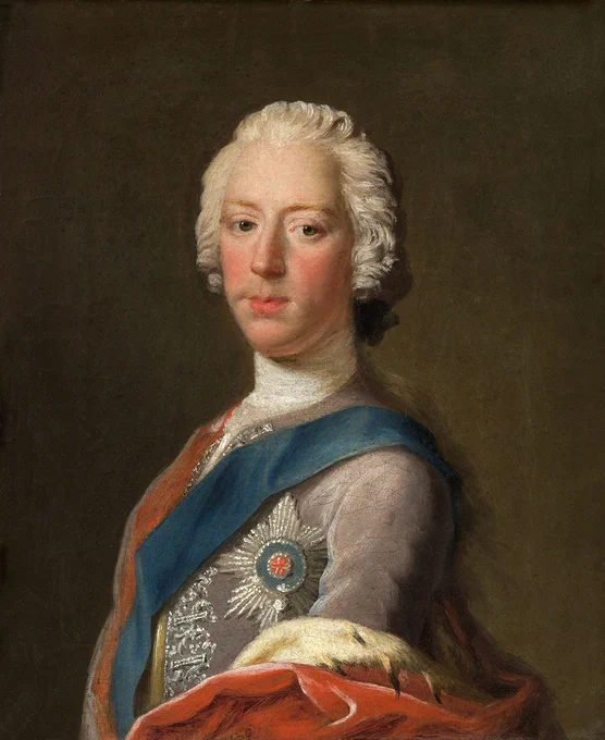 An oil painting of Prince Charles Edward Stuart by eighteenth century artist Allan Ramsay. The painting shows a portrait of the prince looking out at the painter/viewer. The prince is wearing a grey outfit with silver details and a blue sash. He is also wearing a cape made from heavy red fabric and fur.