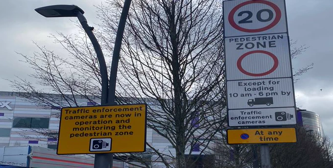 Two road signs, which explain that traffic enforcement cameras are now operating