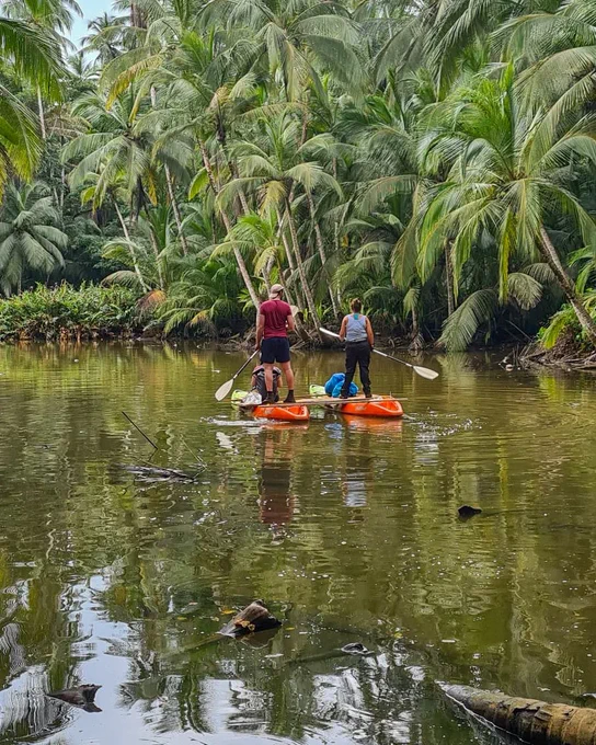 The team paddling their raft in a lagoon. 