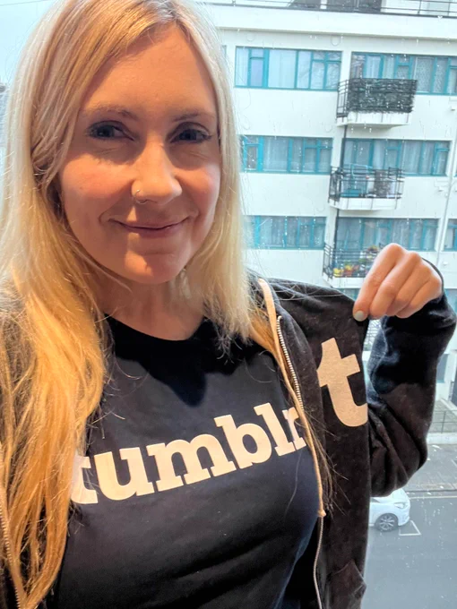 Smiling selfie at my apartment wearing a navy tumblr tee and gray tumblr hoodie