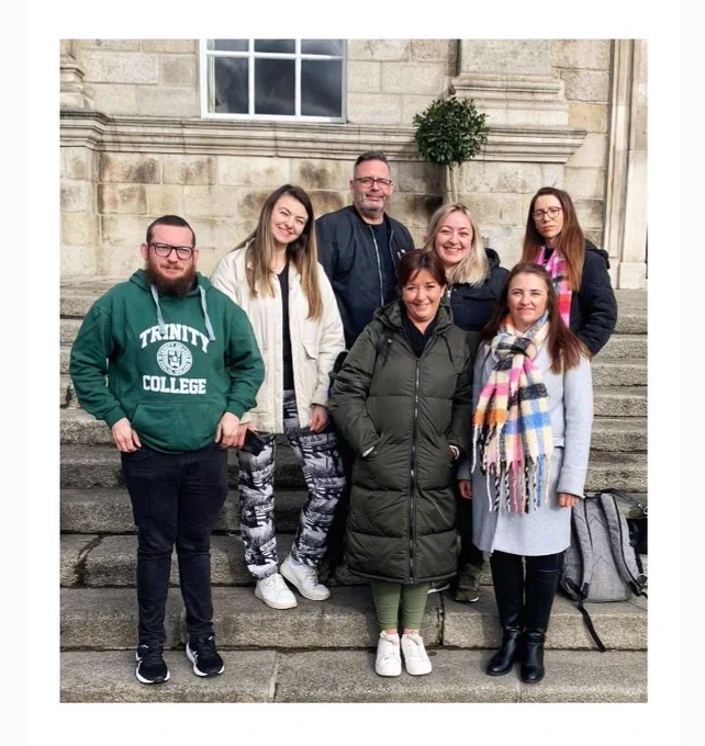 Students in a group on steps at University of Dublin.