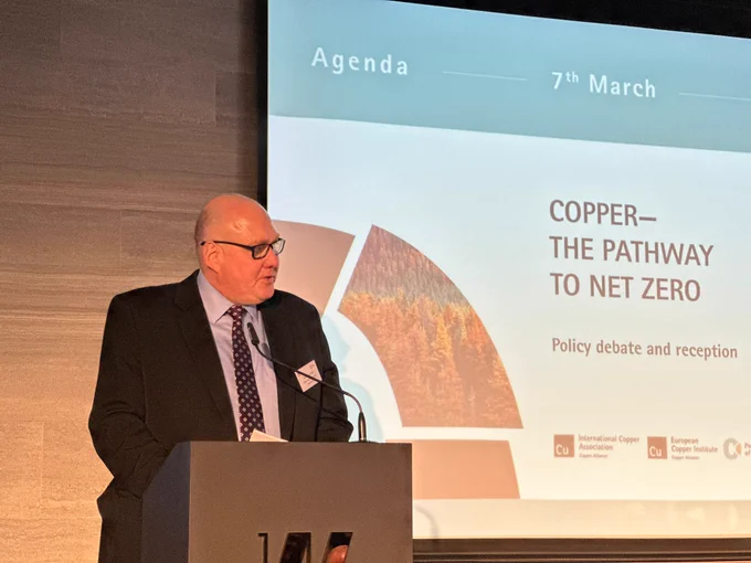 Image of ICA President Tony Lea standing at podium in front of projector screen launching Copper--The Pathway to Net Zero
