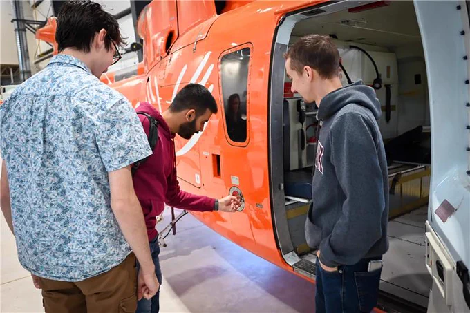 Students from the Mohawk Aviation Club looking at a plane.