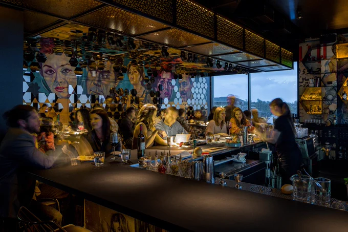 an evening view of city skyline from inside a restaurant