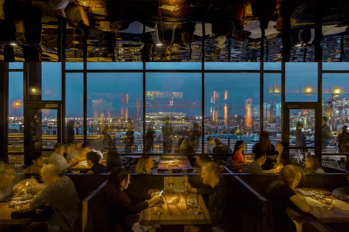 an evening view of city skyline from inside a restaurant