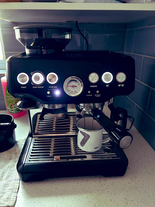 Barista espresso machine with daily.dev mug under it