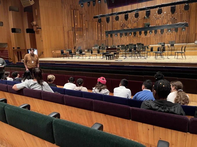 A group of students from Lime Academy Hornbeam having presentation from production & backstage staff at The Barbican