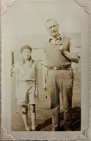 Image of Elizabeth King holding her geology hammer.