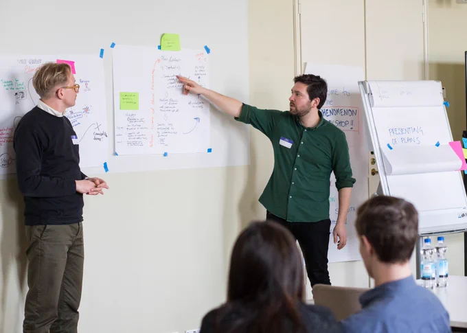 Two partner representatives presenting their marketing idea to the group