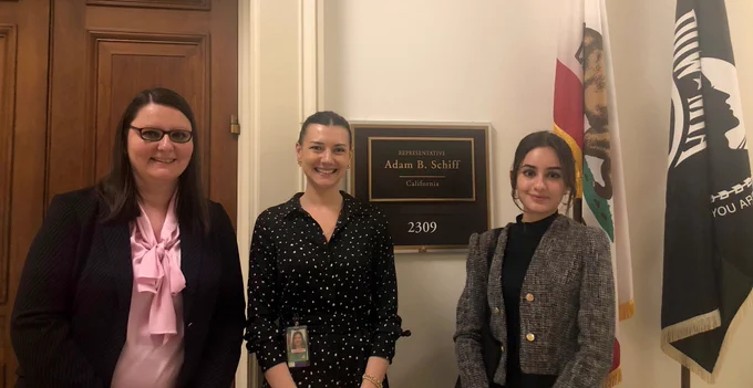 Photo of three people standing in front of a sign for Rep. Adam Schiff. From left to right: UC Federal Governmental Relations staff member Adriana, Rep. Adam Schiff staff member Kaitlyn and UC Federal Governmental Relations intern Mary. 