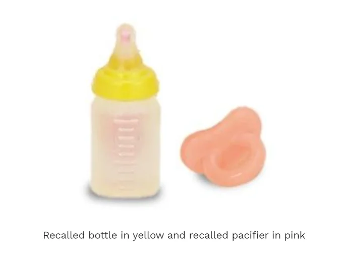 Recalled bottle in yellow and recalled pacifier in pink