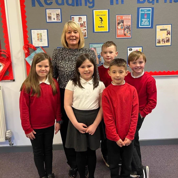 Head Teacher Burnside Primary SChool Mrs Goodwin standing with some children from the school